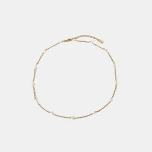 a bracelet with pearls on a white background