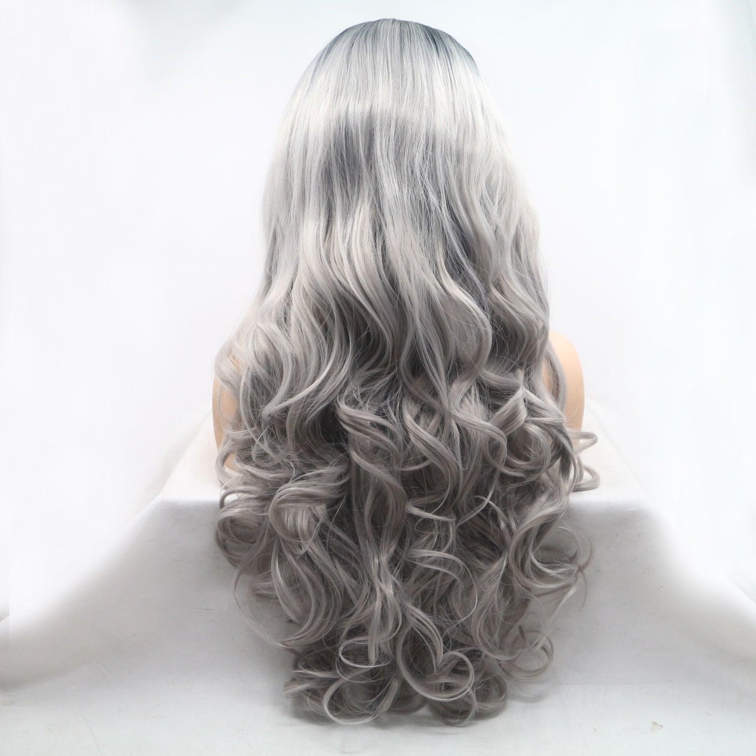 a woman with long grey hair sitting in a chair