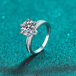 a diamond ring sitting on top of a blue surface
