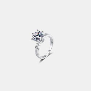 a white gold ring with a single diamond