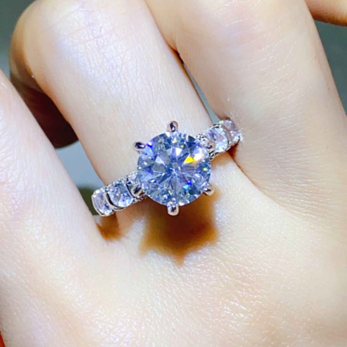 a close up of a person's hand with a ring on it