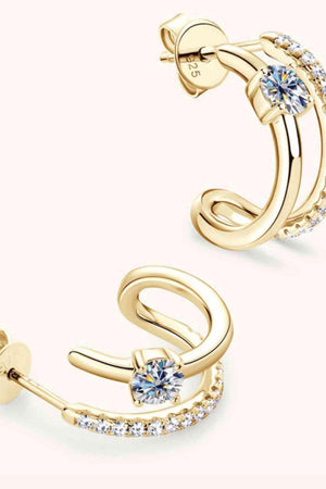 a pair of gold earrings with crystal stones