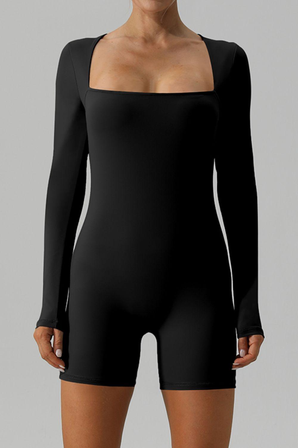 a woman wearing a black bodysuit with long sleeves
