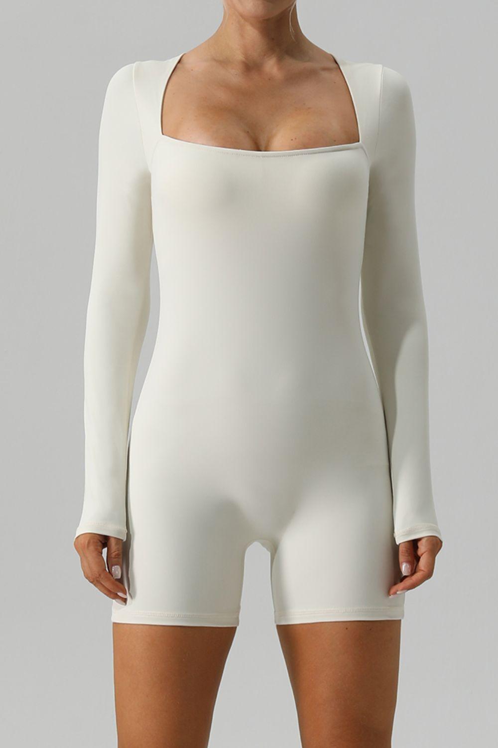 a woman in a white bodysuit posing for a picture