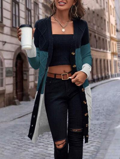 a woman walking down a street holding a cup of coffee
