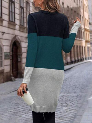 a woman walking down a street wearing a sweater