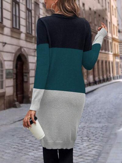 a woman walking down a street wearing a sweater