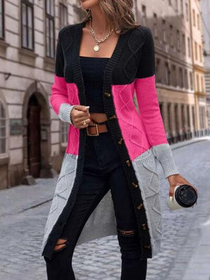 a woman wearing a pink and black cardigan