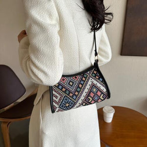 a woman in a white coat holding a purse