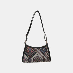 a black and white purse with a black strap