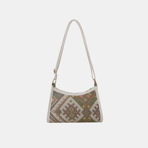 a cross body bag with a pattern on the front