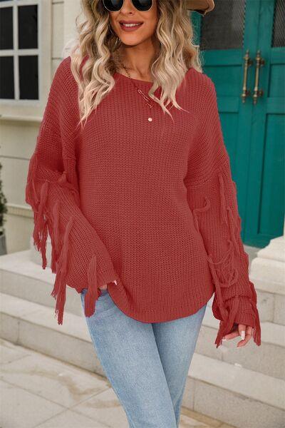 a woman wearing a red sweater and jeans