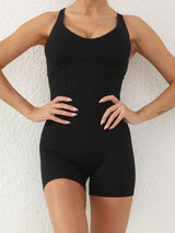 a woman in a black bodysuit posing for a picture