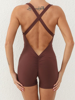 a woman wearing a brown swimsuit with a cross back