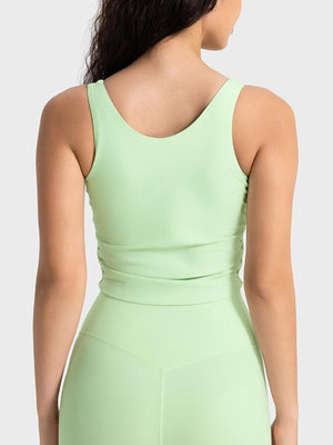 the back of a woman wearing a light green bodysuit