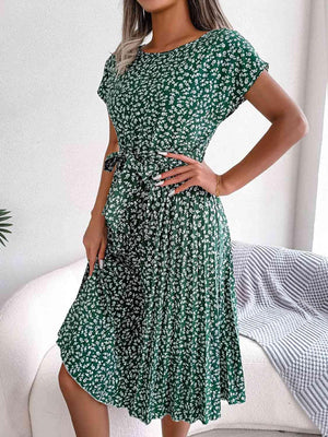 a woman in a green dress posing for the camera
