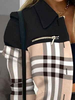 a woman wearing a jacket with a check pattern