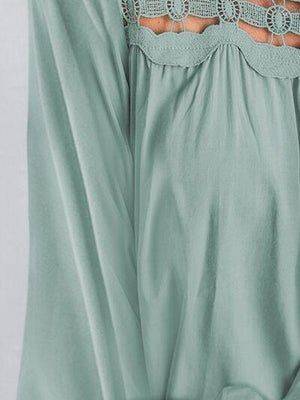 a woman wearing a green dress with cut outs