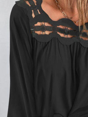 a woman wearing a black top with cut outs