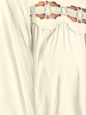 a woman wearing a white blouse with crochet detail