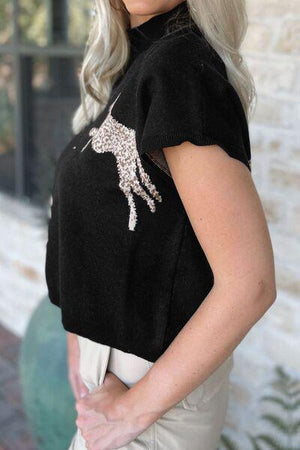 a woman with blonde hair wearing a black top