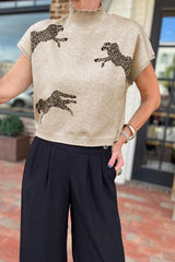 a woman wearing a sweater with a pair of giraffes on it