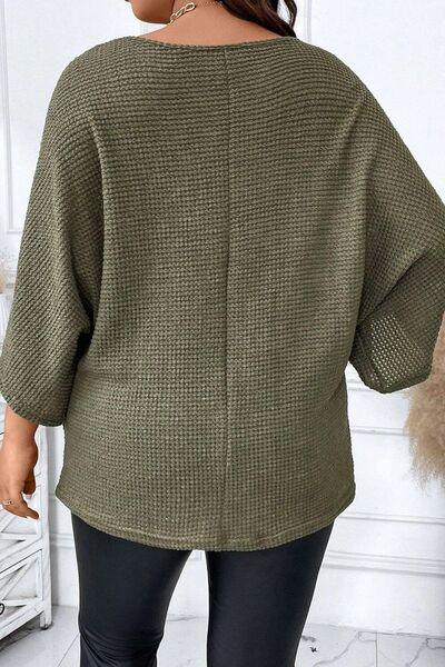 a woman wearing a green sweater and black leggings