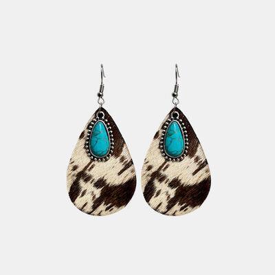 a pair of earrings with a turquoise stone