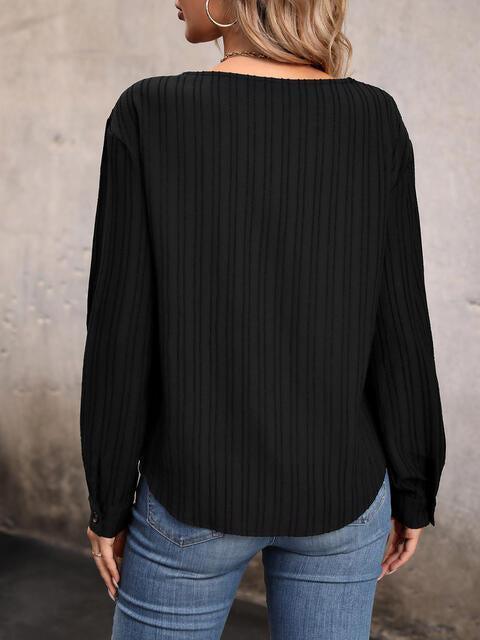a woman wearing a black top and jeans