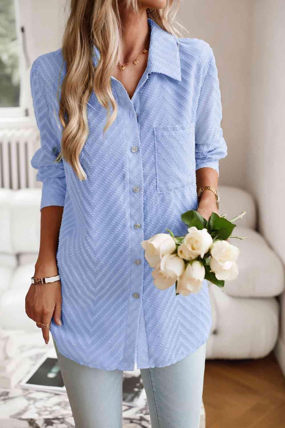 a woman in a blue shirt holding a bouquet of flowers