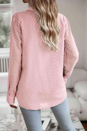 a woman wearing a pink sweater and jeans