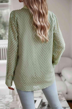 a woman wearing a green sweater and jeans