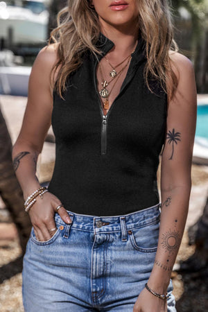 a woman wearing a black top and jeans