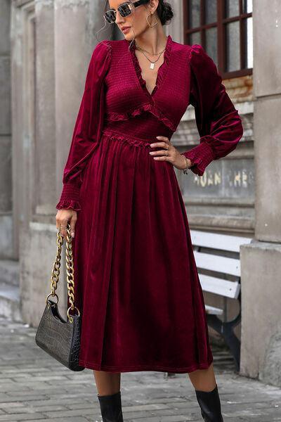 a woman wearing a red dress and black boots