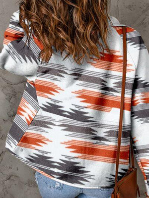 a woman with long hair wearing a sweater and jeans