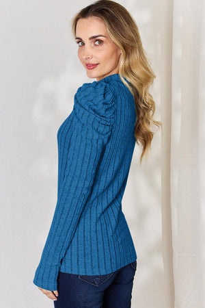a woman wearing a blue sweater and jeans