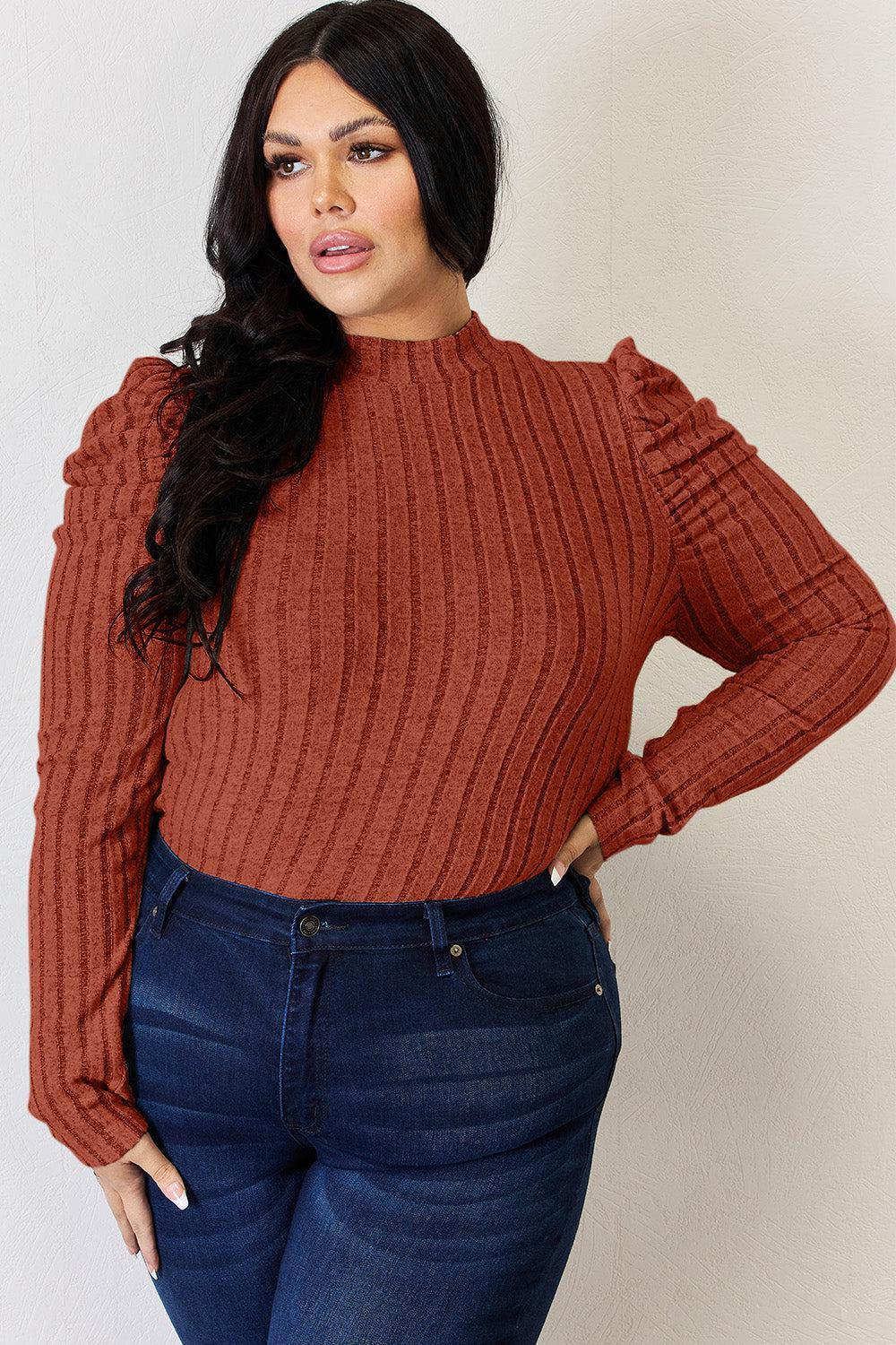 a woman wearing a red sweater and jeans