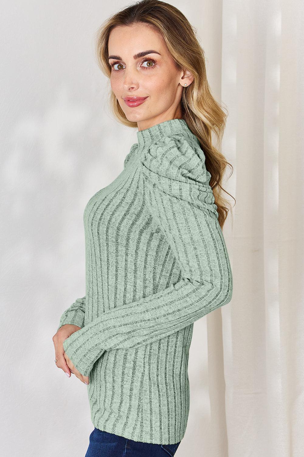 a woman wearing a green turtle neck sweater