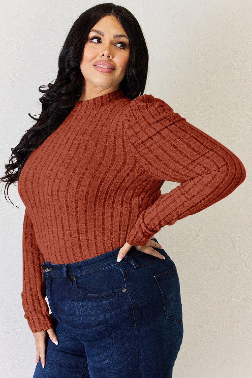 a woman wearing a brown sweater and jeans