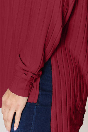 a woman wearing a red blouse and jeans