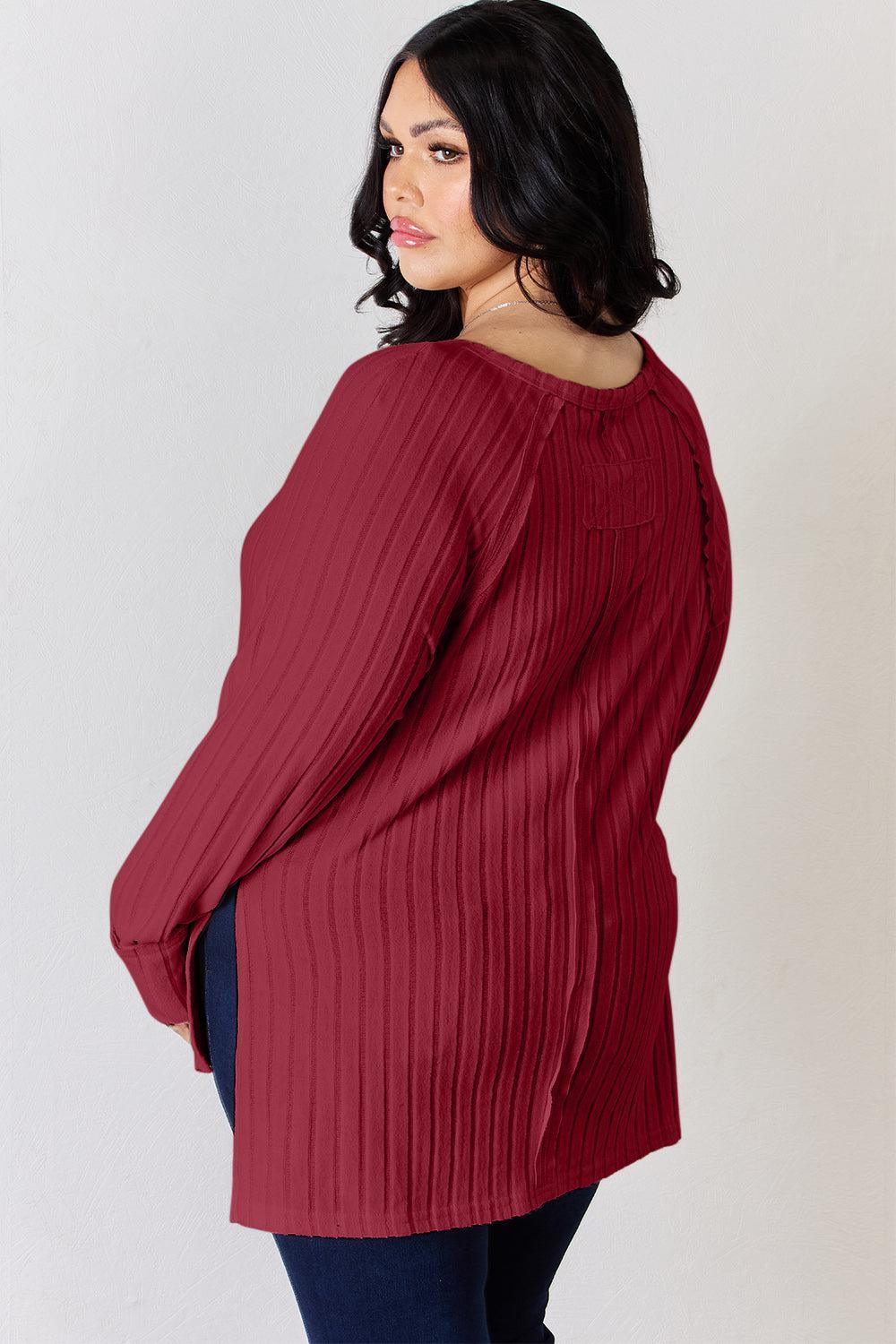a woman wearing a red sweater and jeans