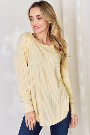 a woman wearing a beige sweater and jeans