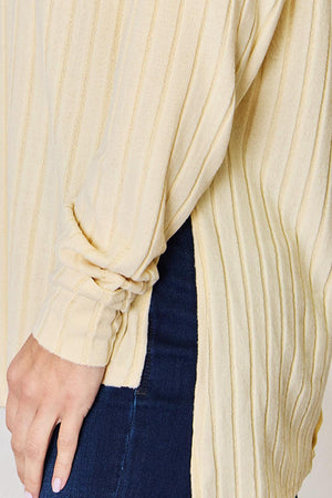 a close up of a person wearing a sweater and jeans