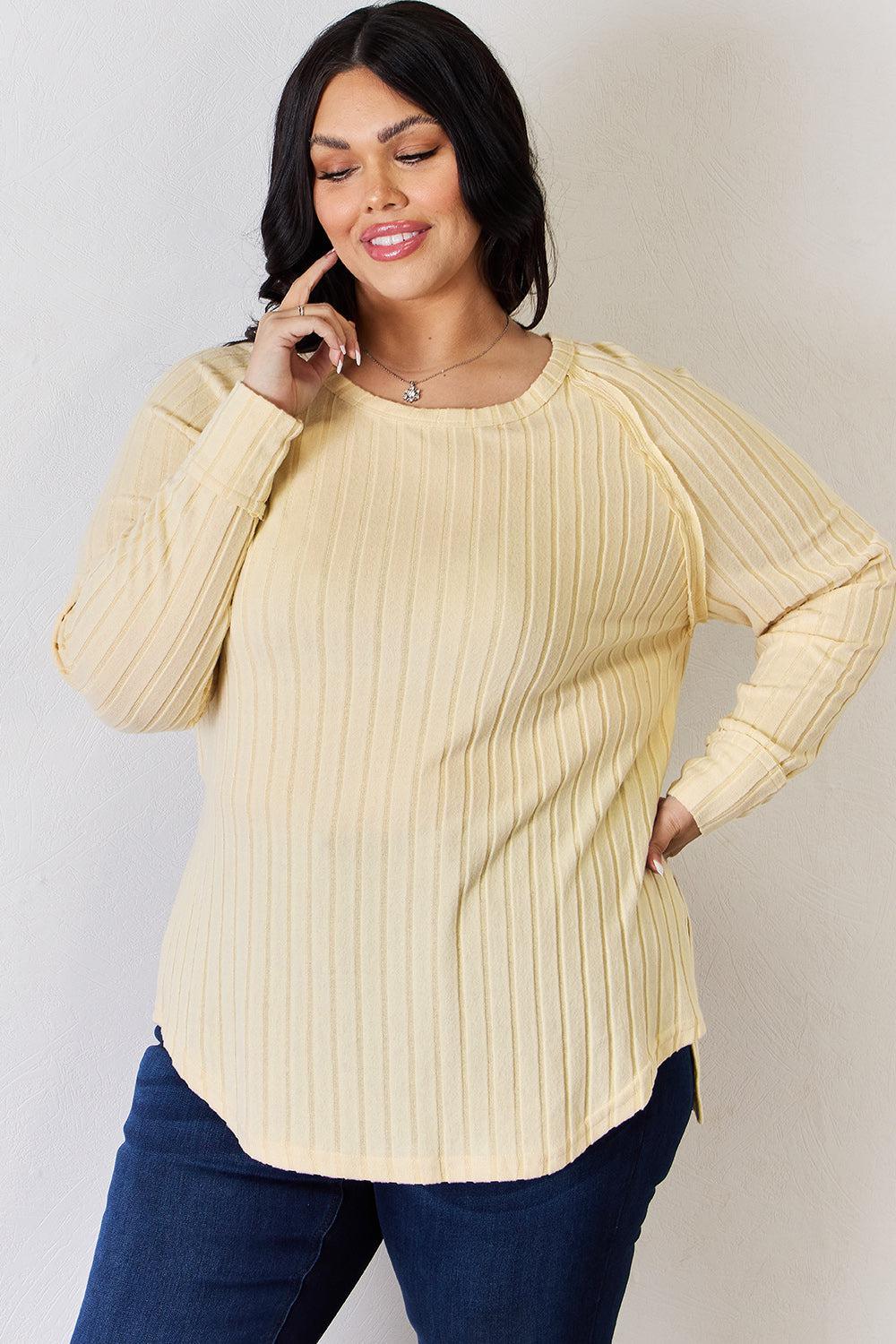 a woman in a yellow sweater talking on a cell phone