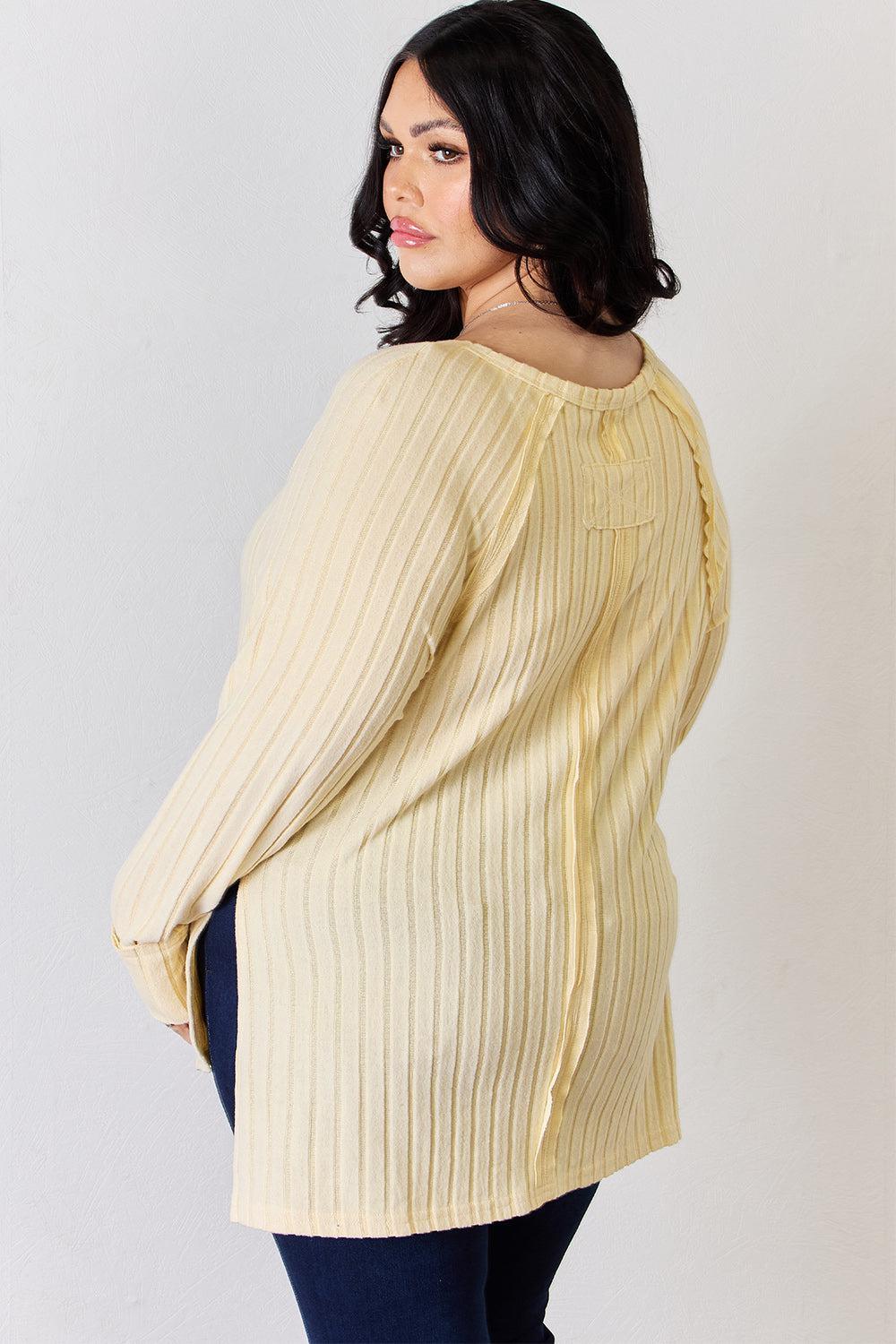 a woman wearing a yellow sweater and jeans