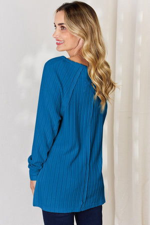 a woman wearing a blue blouse and jeans