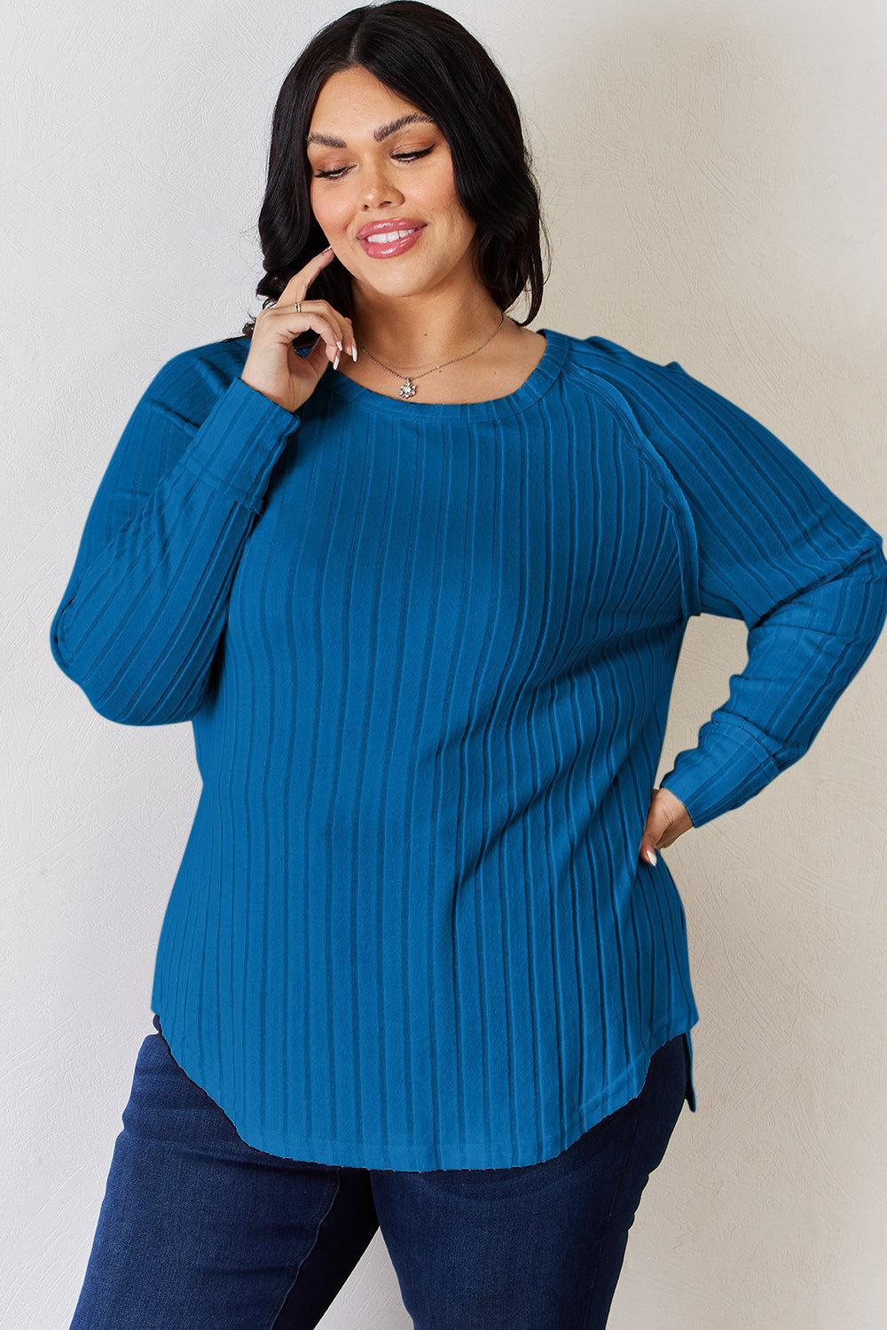 a woman in a blue sweater talking on a cell phone