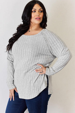 a woman in jeans and a sweater posing for a picture