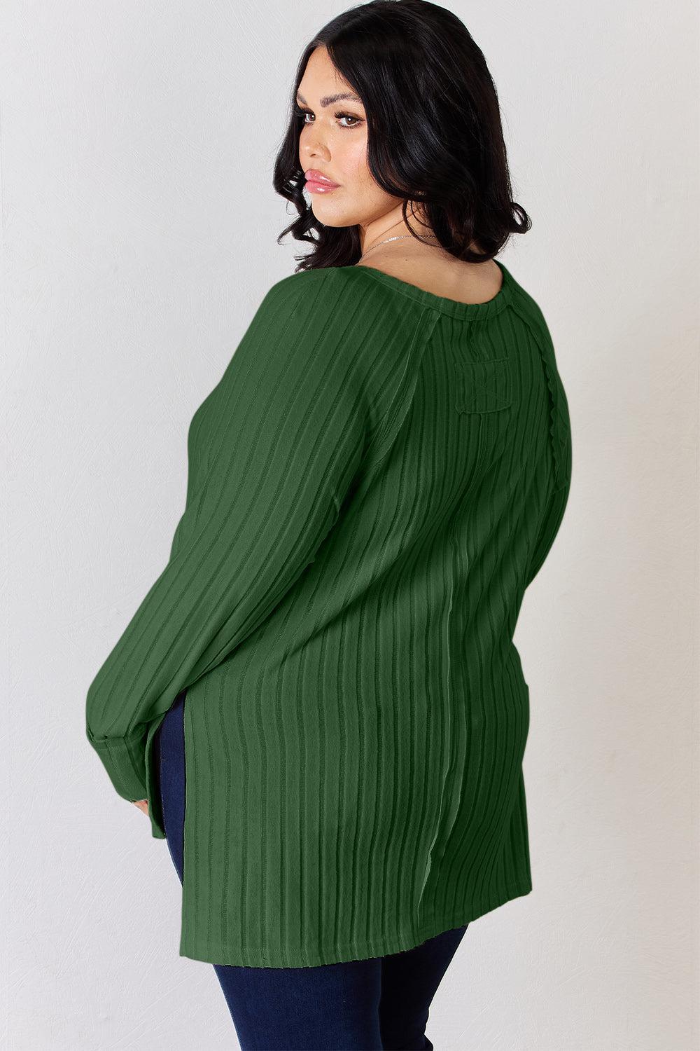 a woman wearing a green sweater and jeans
