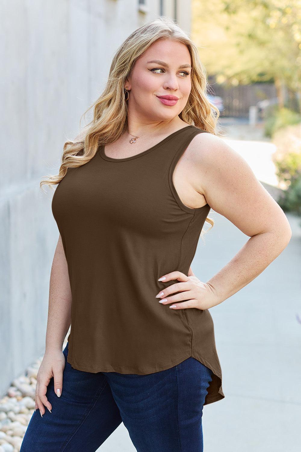 a woman in a brown top posing for a picture
